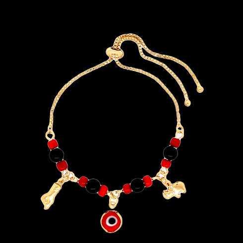 This Red and Black Evil Eye bracelet, adorned with 14k gold-filled Figa hand and Elephant lucky charms, features a striking combination of red and black beads. It is elegantly finished with an adjustable sliding clasp and two delicate gold dangling strands for a perfect fit.